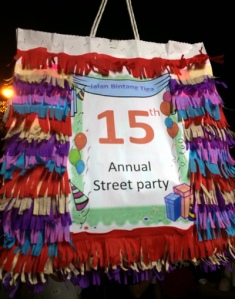 Another tradition - A piñata showing the age of the party hanging high in the middle of the street.